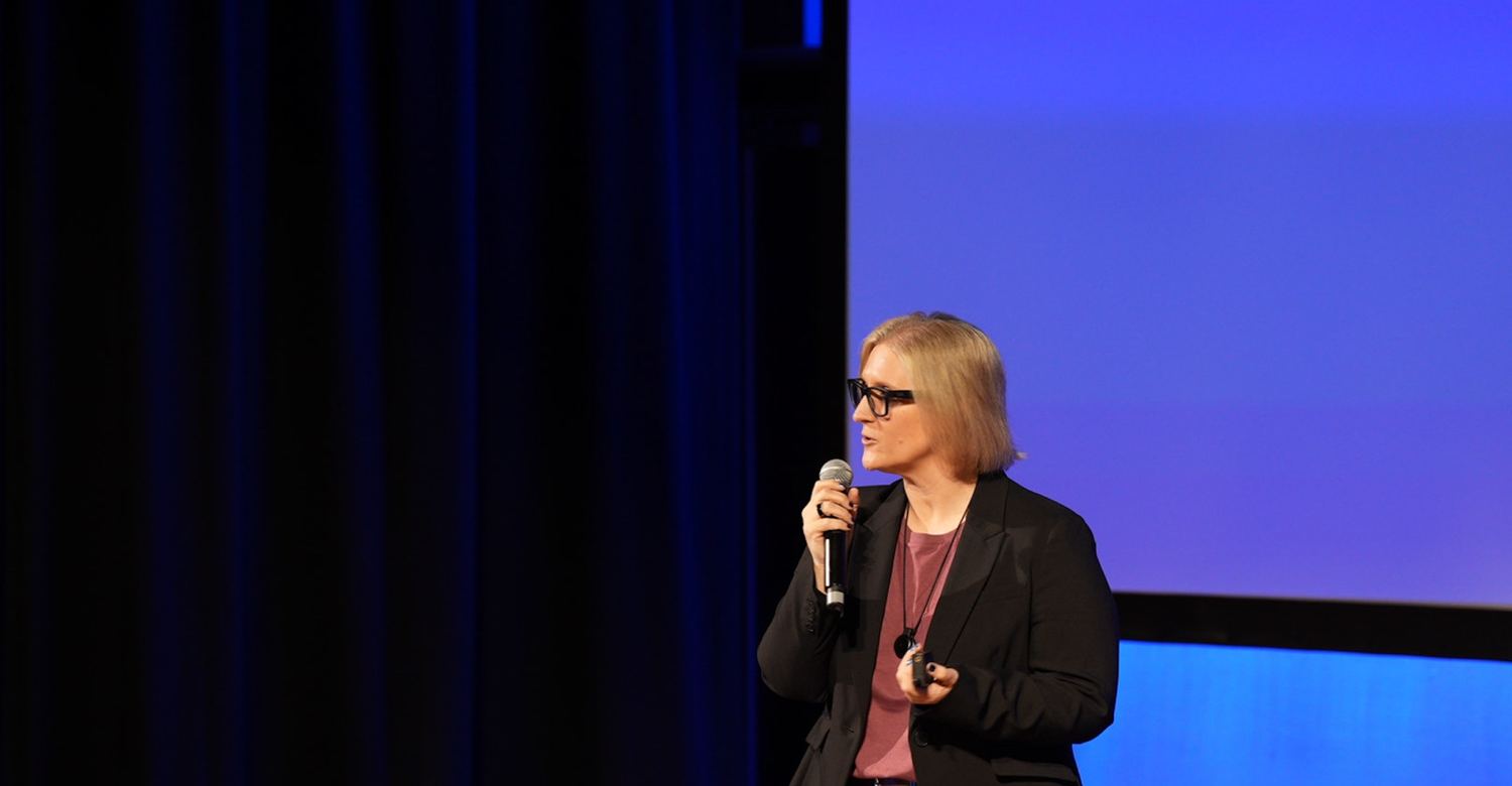 Tracy speaking on stage