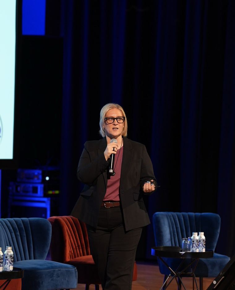 Tracy presenting on stage