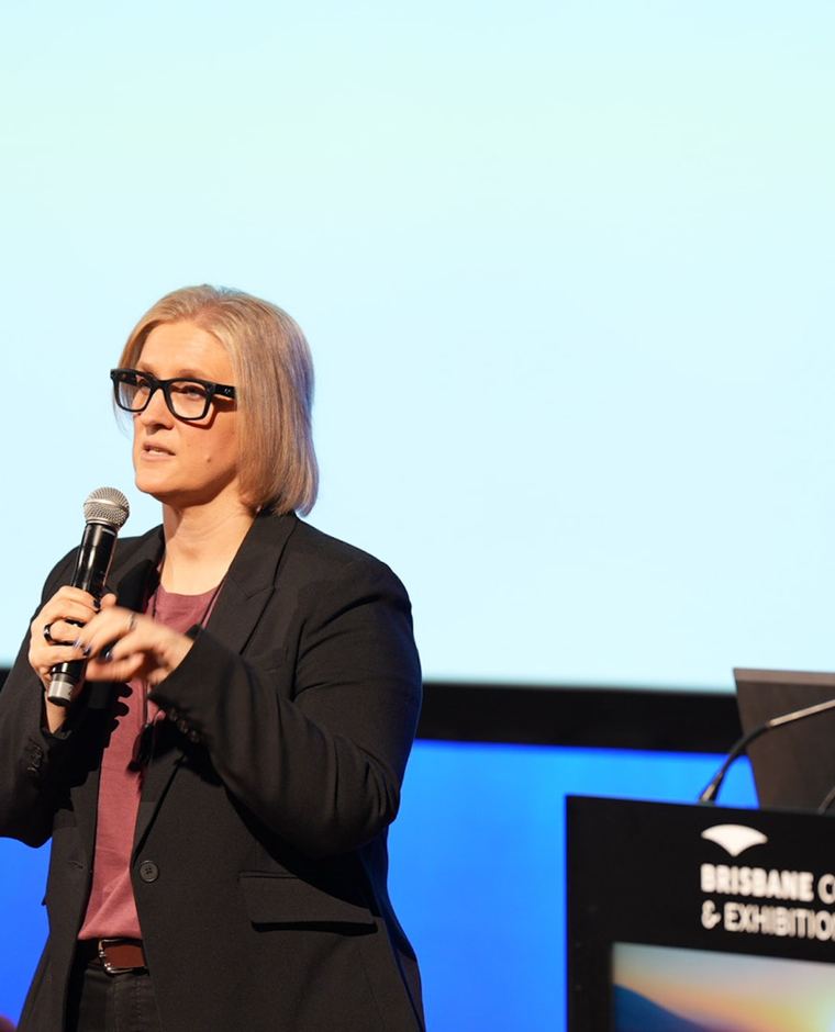 Tracy presenting on stage